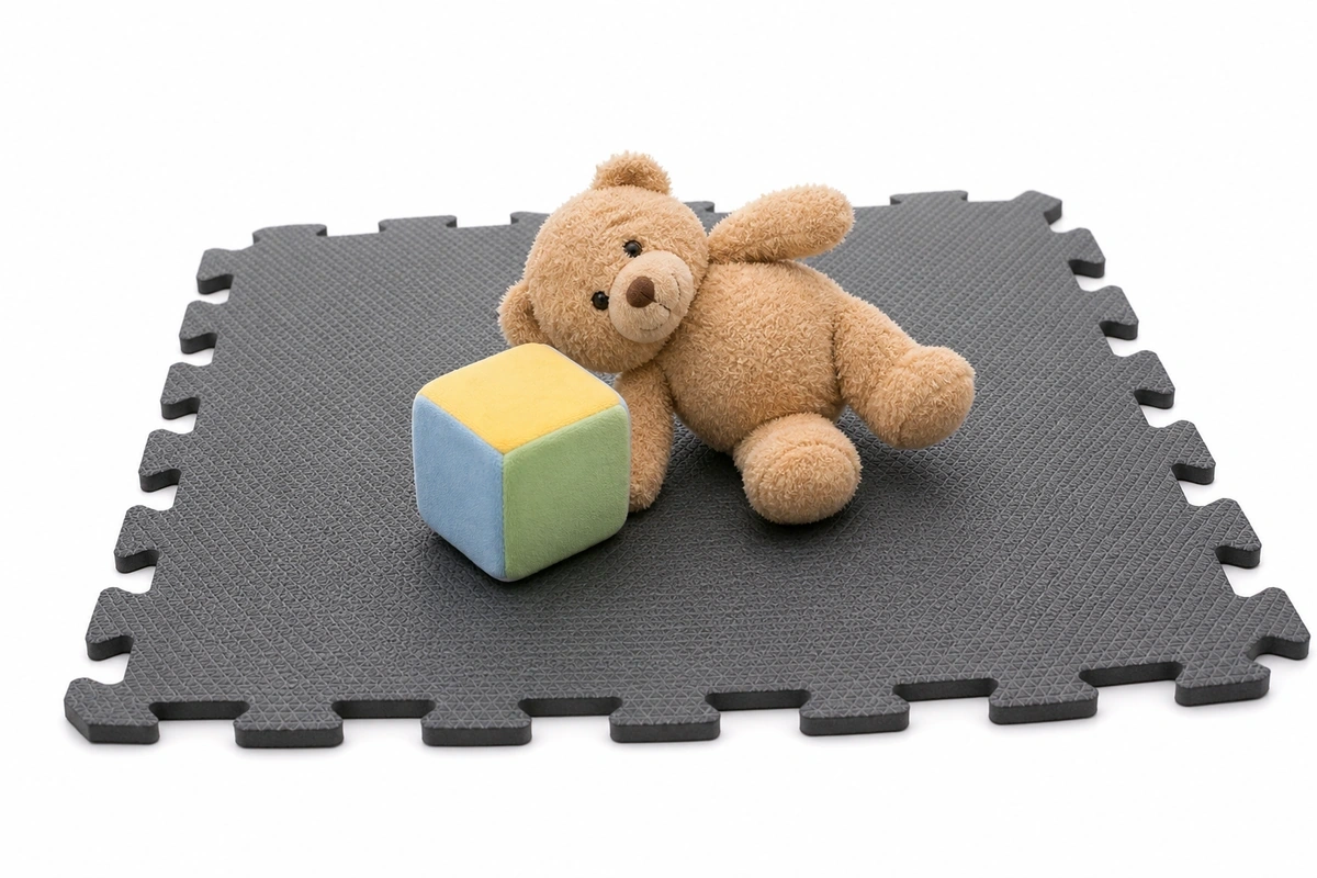 Soft toys resting on a thick foam play mat tile showing fall cushioning