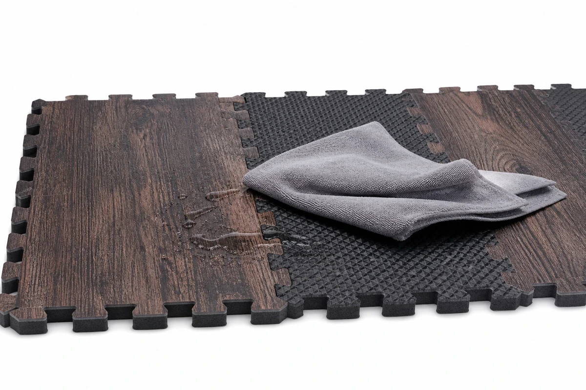 Parent hand wiping foam play mat with cloth for easy cleanup and maintenance