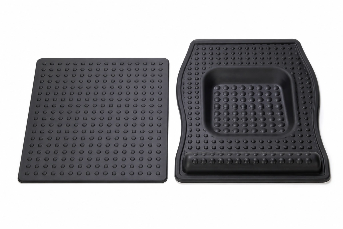 A flat anti-fatigue mat next to a contoured terrain mat with sculpted features